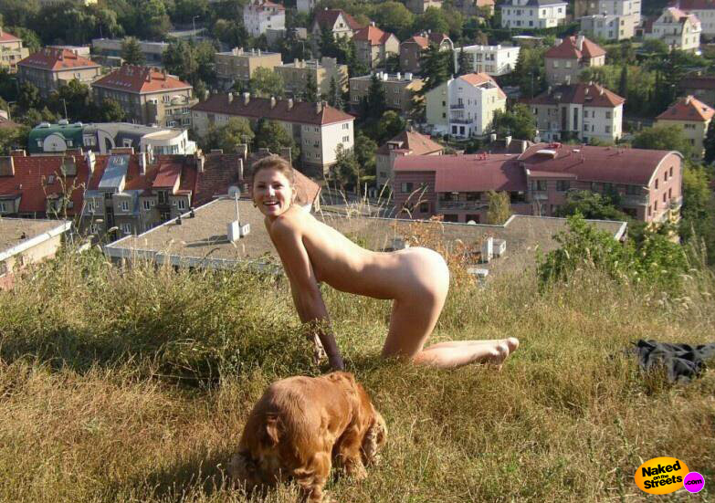 Hot girl pretends to be a dog outdoors