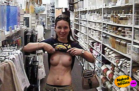 Toned chick shows her boobies in department store