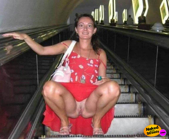 Hottie shows her snatch on an escalator