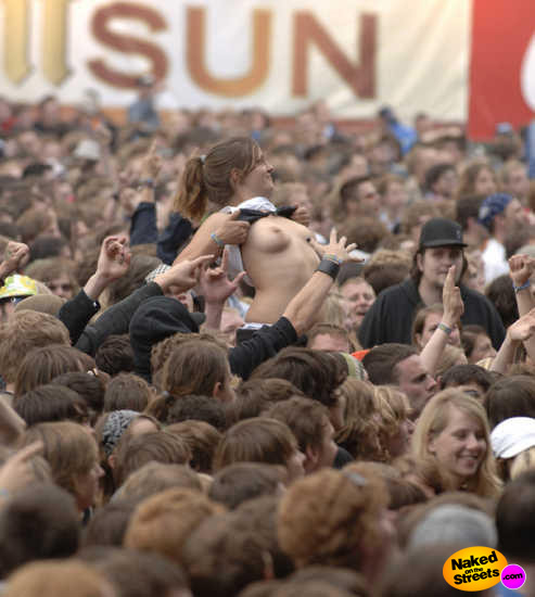 Tit flashing whore towering above the rest of the concert goers