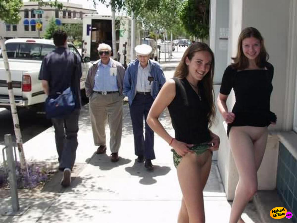 Two teens show their snatches on the sidewalk