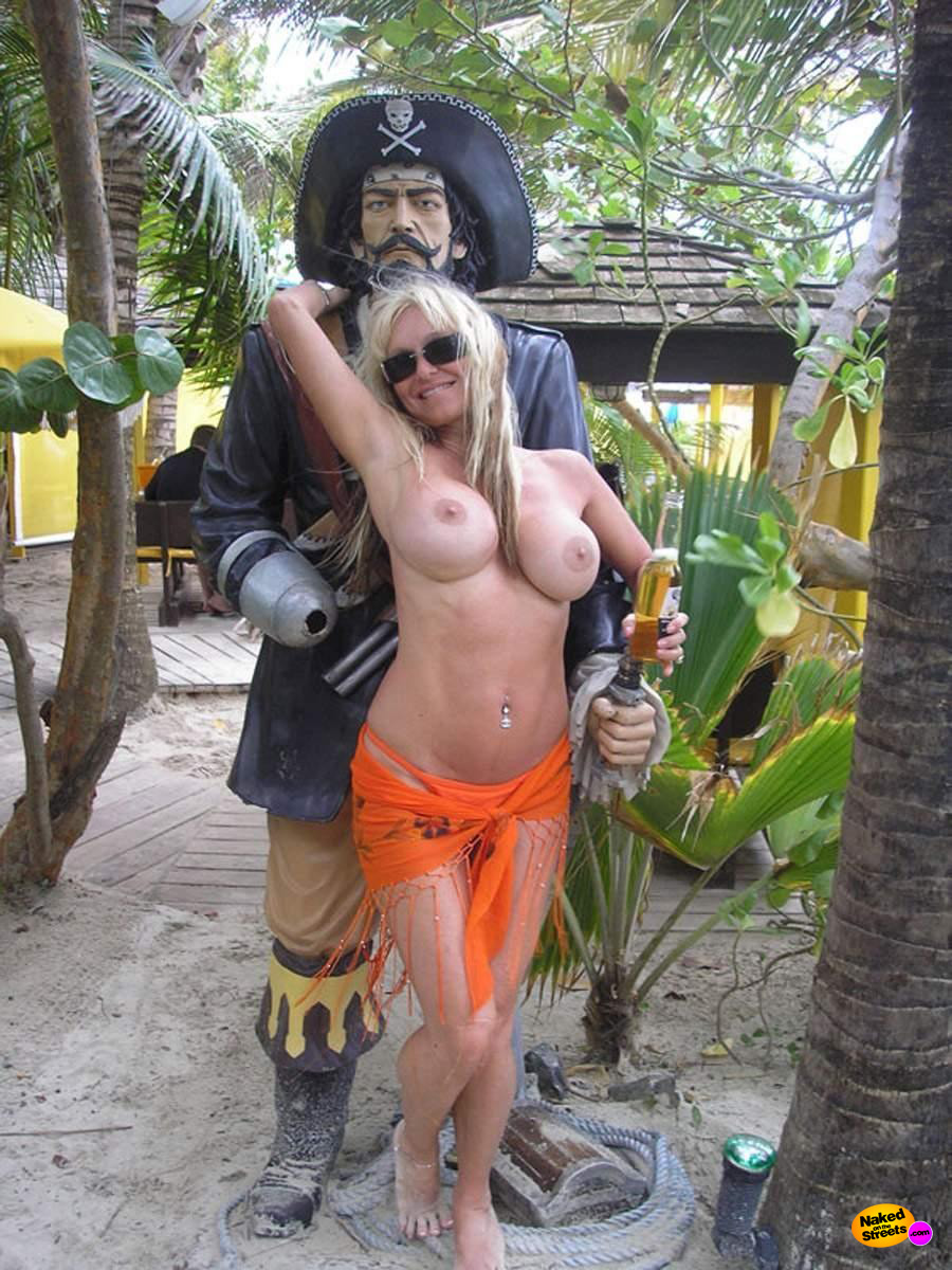 Fake titted girl poses in front of a pirate