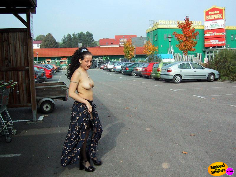 Crazy amateur slut walks topless on a big parking lot