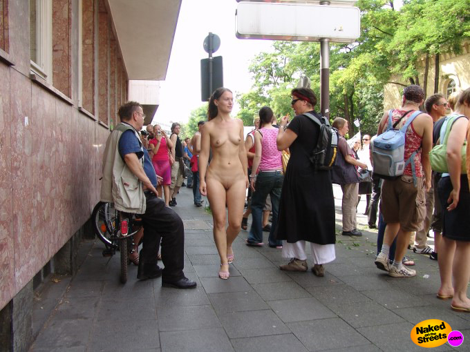 Hot girl walks on the sidewalk fully naked
