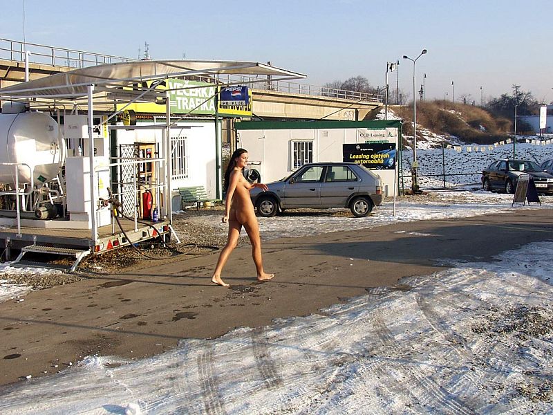 Sexy German girl posing fully nude on a snowy car park