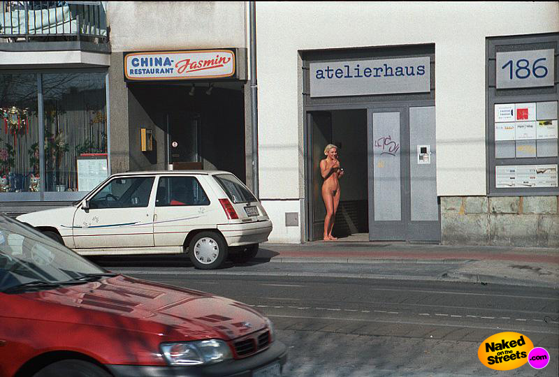 She's fully nude on the streets, but she still seems shy.. how paradoxical!