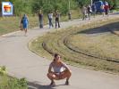 Horny young brunette flashing her pussy on a sidewalk with people coming her way