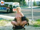 Crazy old chick flashing her big tits and pussy near a city street