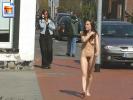 Small teen chick with a retro 70s bush walks nude on the street