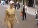 Naughty girl with a pink baseball cap walks naked on the streets