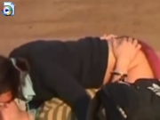 Drunk girl riding boyfriend on public beach