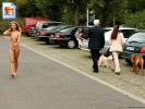 Skinny blonde chick walking around a carpark fully nude